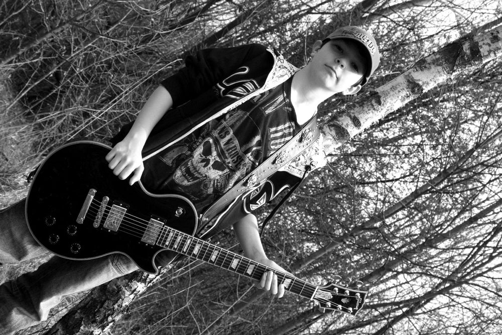 Nando Timpe with his guitar at around eight years old